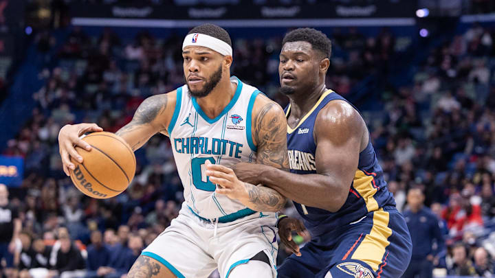 Jan 17, 2024; New Orleans, Louisiana, USA;  Charlotte Hornets forward Miles Bridges (0) dribbles against New Orleans Pelicans forward Zion Williamson (1) during the second half at Smoothie King Center. Mandatory Credit: Stephen Lew-Imagn Images