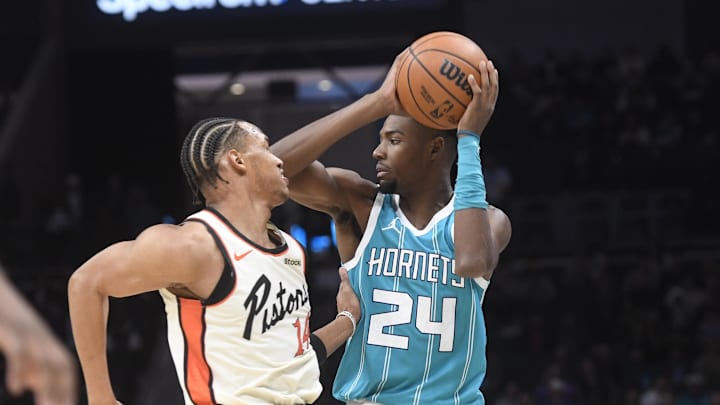 Nov 21, 2024; Charlotte, North Carolina, USA;  Charlotte Hornets forward Brandon Miller (24) looks to pass as he is defended by Detroit Pistons Wendell Moore Jr. (14) during the second half at the Spectrum Center. Mandatory Credit: Sam Sharpe-Imagn Images