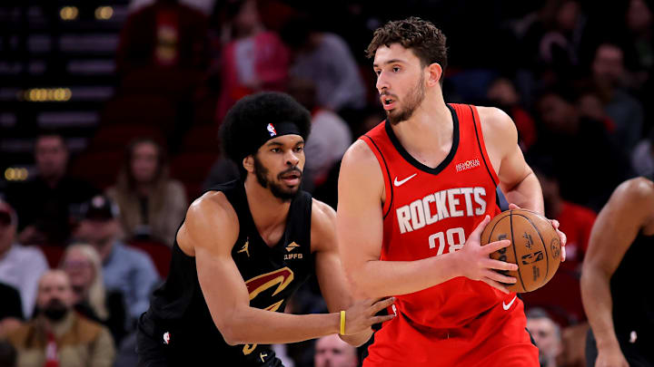 Jan 22, 2025; Houston, Texas, USA; Houston Rockets center Alperen Sengun (28) handles the ball against Cleveland Cavaliers center Jarrett Allen (31) during the first quarter at Toyota Center. Mandatory Credit: Erik Williams-Imagn Images