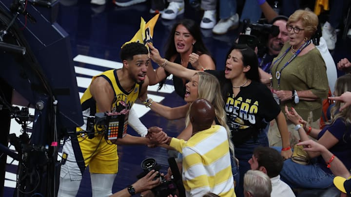 Jun 13, 2025; Indianapolis, Indiana, USA; Indiana Pacers guard Tyrese Haliburton (0) reacts with his girlfriend Jade Jones and father John Haliburton following the second quarter against the Oklahoma City Thunder in game four of the 2025 NBA Finals at Gainbridge Fieldhouse. Mandatory Credit: Trevor Ruszkowski-Imagn Images