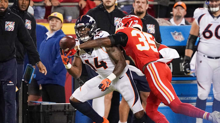 Oct 12, 2023; Kansas City, Missouri, USA; Kansas City Chiefs cornerback Jaylen Watson (35) breaks up a pass intended for Denver Broncos wide receiver Courtland Sutton (14) during the second half at GEHA Field at Arrowhead Stadium. Mandatory Credit: Denny Medley-USA TODAY Sports
