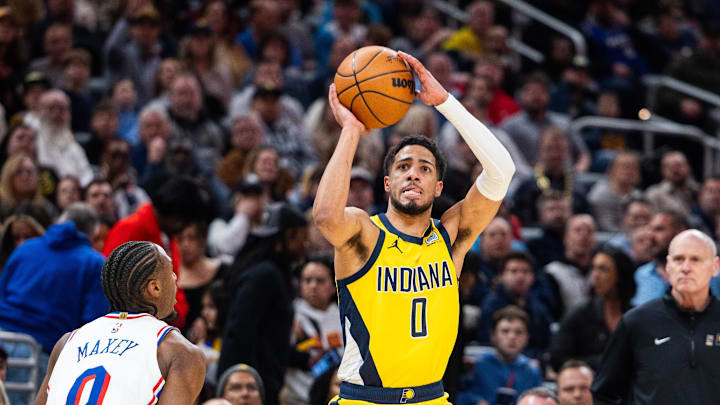 Jan 18, 2025; Indianapolis, Indiana, USA; Indiana Pacers guard Tyrese Haliburton (0) shoots the ball while Philadelphia 76ers guard Tyrese Maxey (0) defends in the first half at Gainbridge Fieldhouse. Mandatory Credit: Trevor Ruszkowski-Imagn Images