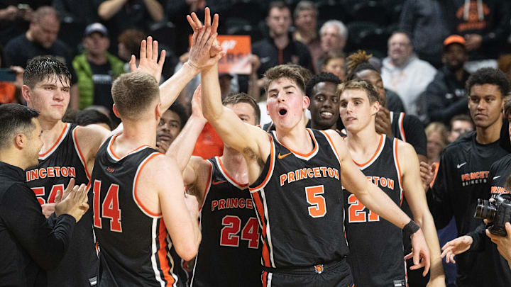 Members of the Princeton men's basketball team celebrate after Princeton defeated Rutgers, 68-61, in
