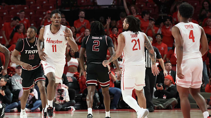 Dec 10, 2024; Houston, Texas, USA; Houston Cougars forward Joseph Tugler (11) reacts to his basket against there Troy Trojans in the first half at Fertitta Center. Mandatory Credit: Thomas Shea-Imagn Images
