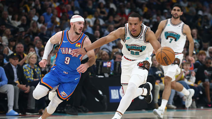 Apr 24, 2025; Memphis, Tennessee, USA; Memphis Grizzlies guard Desmond Bane (22) dribbles as Oklahoma City Thunder guard Alex Caruso (9) defends during the second quarter during game three for the first round of the 2025 NBA Playoffs at FedExForum. Mandatory Credit: Petre Thomas-Imagn Images