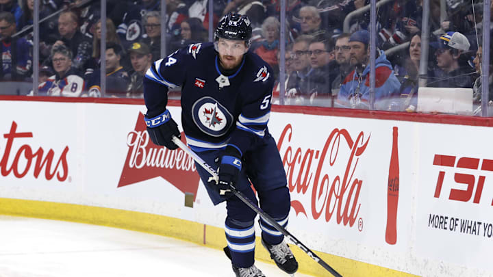 Apr 7, 2025; Winnipeg, Manitoba, CAN; Winnipeg Jets defenseman Dylan Samberg (54) skates up the ice against the St. Louis Blues in the first period at Canada Life Centre. Mandatory Credit: James Carey Lauder-Imagn Images