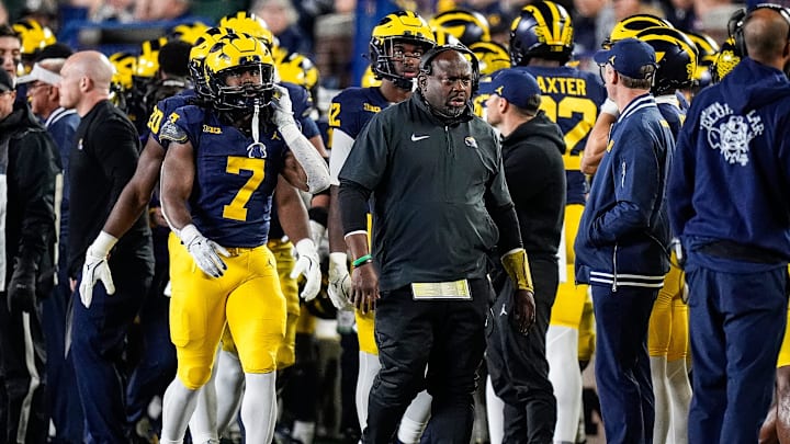 Michigan running back coach Tony Alford, right, and running back Donovan Edwards, left, walk along the sideline during the first half against Michigan State at Michigan Stadium in Ann Arbor on Saturday, Oct. 26, 2024.