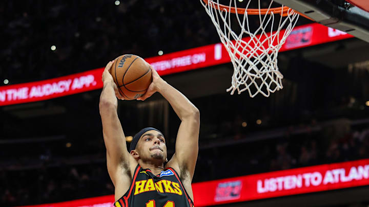Dec 26, 2025; Atlanta, Georgia, USA; Atlanta Hawks forward Asa Newell (14) dunks the ball against the Miami Heat during the fourth quarter at State Farm Arena. Mandatory Credit: Jordan Godfree-Imagn Images