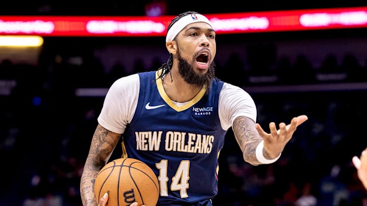 Dec 5, 2024; New Orleans, Louisiana, USA;  New Orleans Pelicans forward Brandon Ingram (14) reacts to a play against Phoenix Suns guard Devin Booker (1) during the first half  at Smoothie King Center. Mandatory Credit: Stephen Lew-Imagn Images