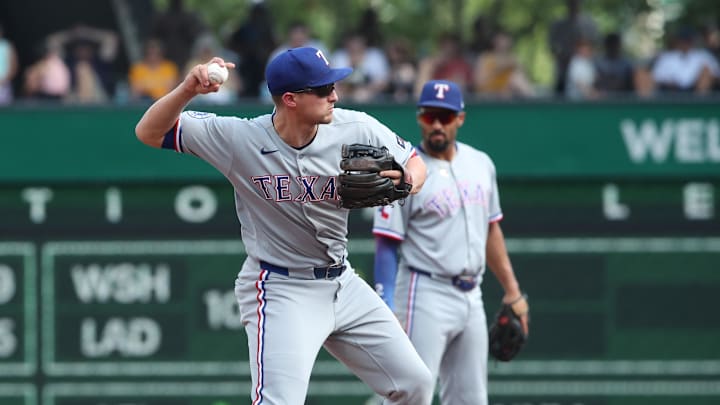 Jun 21, 2025; Pittsburgh, Pennsylvania, USA;  Texas Rangers shortstop Corey Seager (5) throws to first base to complete a double play against the Pittsburgh Pirates during the fourth inning at PNC Park.