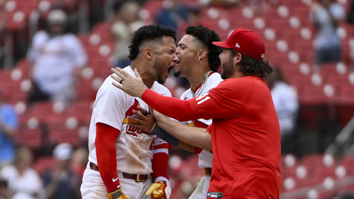 Jun 5, 2025; St. Louis, Missouri, USA;  St. Louis Cardinals first baseman Willson Contreras (40) reacts as he is mobbed by shortstop Masyn Winn (0) and left fielder Alec Burleson (41) after hitting a walk-off one run single against the Kansas City Royals during the tenth inning at Busch Stadium. Mandatory Credit: Jeff Curry-Imagn Images