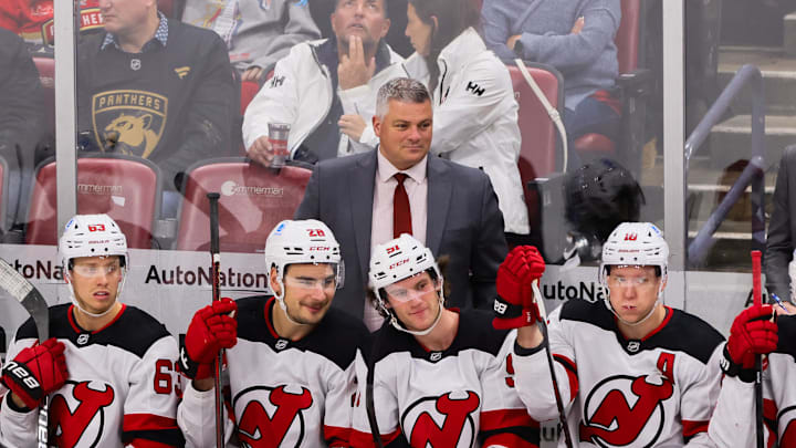 Nov 14, 2024; Sunrise, Florida, USA; New Jersey Devils head coach Sheldon Keefe watches from the bench against the Florida Panthers during the third period at Amerant Bank Arena. Mandatory Credit: Sam Navarro-Imagn Images