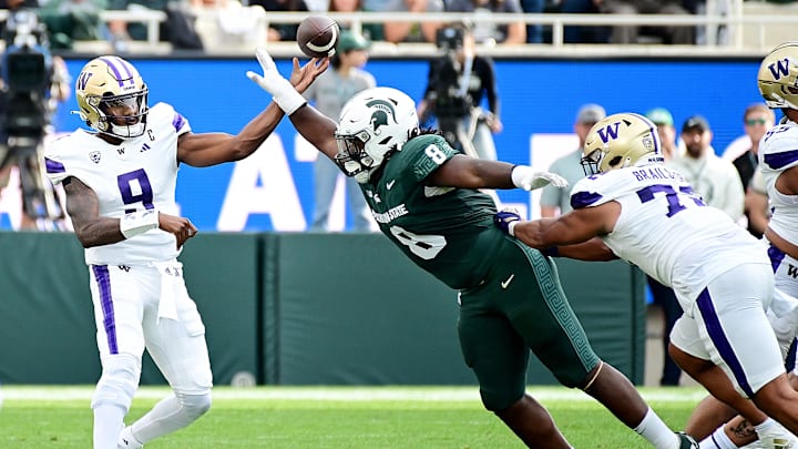 Sep 16, 2023; East Lansing, Michigan, USA; Michigan State Spartans defensive lineman Simeon Barrow Jr. (8) breaks up a pass by Washington Huskies quarterback Michael Penix Jr. (9) in the first quarter at Spartan Stadium. Mandatory Credit: Dale Young-USA TODAY Sports