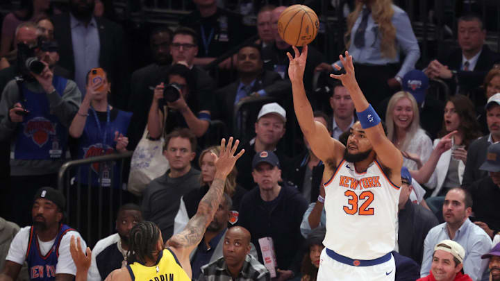 New York Knicks center Karl-Anthony Towns shoots a three point shot against Indiana Pacers forward Obi Toppin.