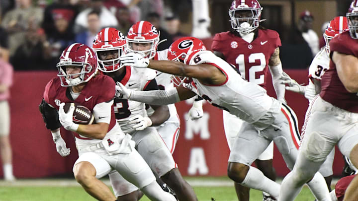 Sep 28, 2024; Tuscaloosa, Alabama, USA;  Georgia Bulldogs defensive back Daylen Everette (6) reaches out for Alabama Crimson Tide wide receiver Cole Adams (7) at Bryant-Denny Stadium. Mandatory Credit: Gary Cosby Jr.-Imagn Images