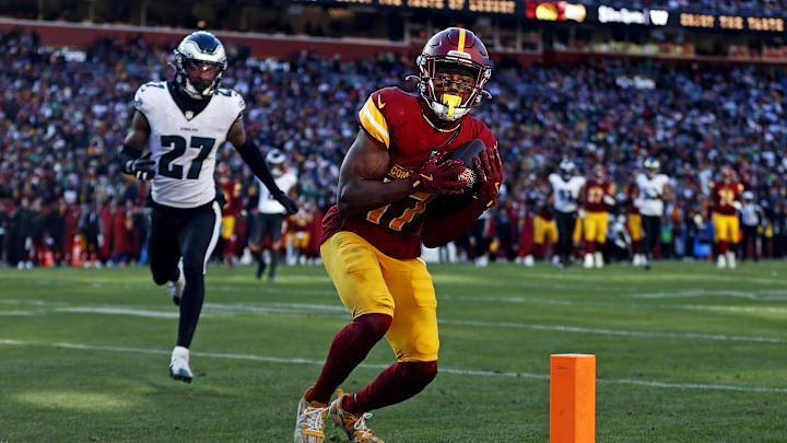 Dec 22, 2024; Landover, Maryland, USA; Washington Commanders wide receiver Terry McLaurin (17) catches a touchdown pass against Philadelphia Eagles cornerback Quinyon Mitchell (27). Dec 22, 2024; Landover, Maryland, USA; Washington Commanders wide receiver Terry McLaurin (17) catches a touchdown pass against Philadelphia Eagles cornerback Quinyon Mitchell (27).