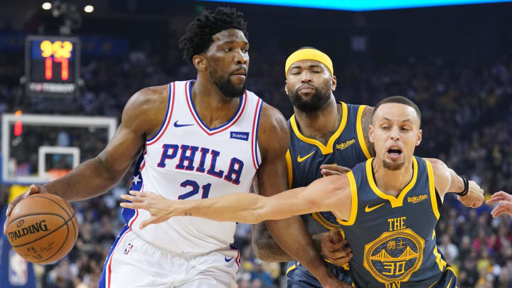 January 31, 2019; Oakland, CA, USA; Philadelphia 76ers center Joel Embiid (21) dribbles the basketball against Golden State Warriors center DeMarcus Cousins (0) and guard Stephen Curry (30) during the first quarter at Oracle Arena. Mandatory Credit: Kyle Terada-USA TODAY Sports January 31, 2019; Oakland, CA, USA; Philadelphia 76ers center Joel Embiid (21) dribbles the basketball against Golden State Warriors center DeMarcus Cousins (0) and guard Stephen Curry (30) during the first quarter at Oracle Arena. Mandatory Credit: Kyle Terada-USA TODAY Sports