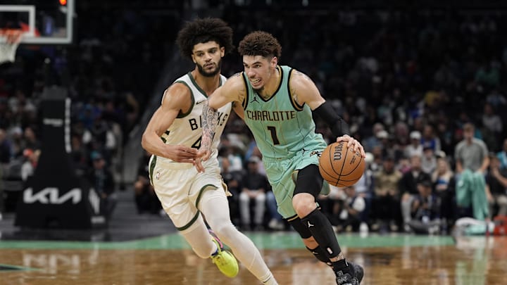 Nov 16, 2024; Charlotte, North Carolina, USA;  Charlotte Hornets guard LaMelo Ball (1) drives to the basket guarded by Milwaukee Bucks guard Andre Jackson Jr. (44) during the second half at Spectrum Center. Mandatory Credit: Jim Dedmon-Imagn Images