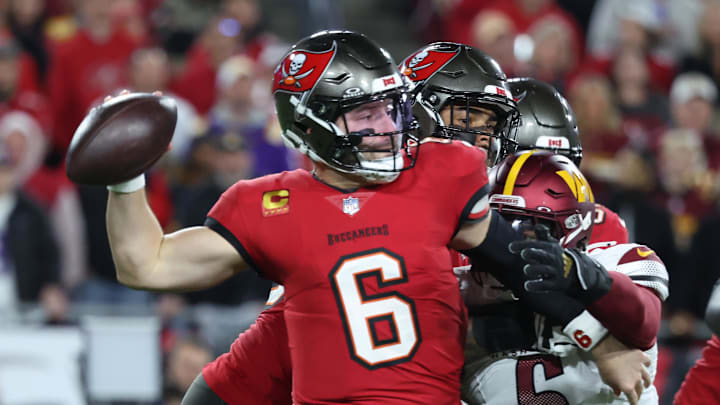 Jan 12, 2025; Tampa, Florida, USA; Tampa Bay Buccaneers quarterback Baker Mayfield (6) throws against Washington Commanders linebacker Dante Fowler Jr. (6) during the second quarter of a NFC wild card playoff at Raymond James Stadium. Mandatory Credit: Kim Klement Neitzel-Imagn Images