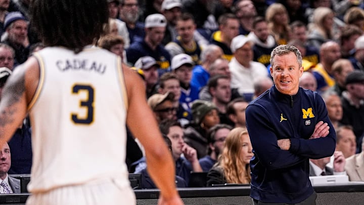 Michigan head coach Dusty May talks to guard Elliot Cadeau (3) before a play against Saint Louis during the first half of NCAA Tournament Second Round at KeyBank Center in Buffalo on Saturday, March 21, 2026.
