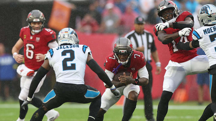 Jan 3, 2026; Tampa, Florida, USA; Tampa Bay Buccaneers running back Bucky Irving (7) runs against Carolina Panthers cornerback Mike Jackson (2) in the first half at Raymond James Stadium. Mandatory Credit: Nathan Ray Seebeck-Imagn Images