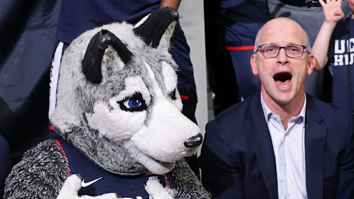 Mar 29, 2026; Washington, DC, USA; UConn Huskies head coach Dan Hurley (R) celebrates with mascot Johnathan the Husky during the trophy ceremony after their game against the Duke Blue Devils in an Elite Eight game of the East Regional of the men's 2026 NCAA Tournament at Capital One Arena.