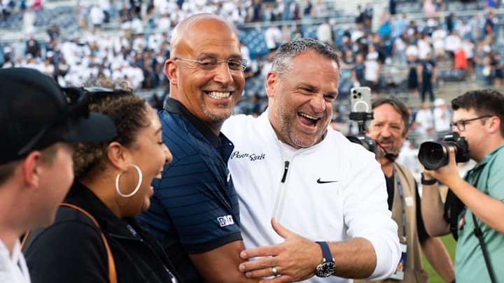 Penn State Athletic Director Pat Kraft, right, laughs with head coach James Franklin following a 46-11 win over Nevada