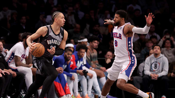 Feb 12, 2025; Brooklyn, New York, USA; Brooklyn Nets forward Jalen Wilson (22) controls the ball against Philadelphia 76ers forward Paul George (8) during the fourth quarter at Barclays Center. Mandatory Credit: Brad Penner-Imagn Images