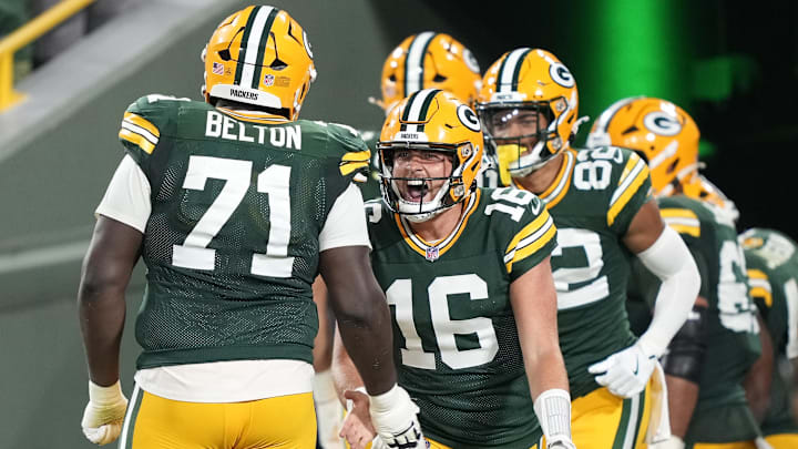 Aug 9, 2025; Green Bay, Wisconsin, USA;  Green Bay Packers quarterback Sean Clifford (16) reacts to a touchdown with offensive tackle Anthony Belton (71) during the second half against the New York Jets at Lambeau Field. Mandatory Credit: Kayla Wolf-Imagn Images