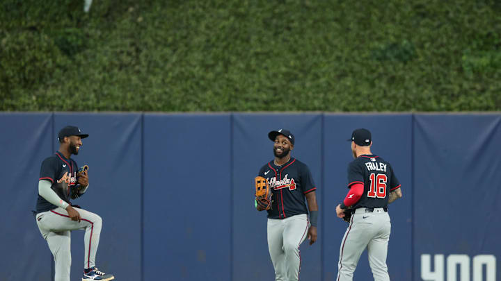 Aug 27, 2025; Miami, Florida, USA; Atlanta Braves left fielder Jurickson Profar (left), center fielder Michael Harris II (center), and right fielder Jake Fraley (right) celebrate after the game against the Miami Marlins at loanDepot Park. Mandatory Credit: Sam Navarro-Imagn Images