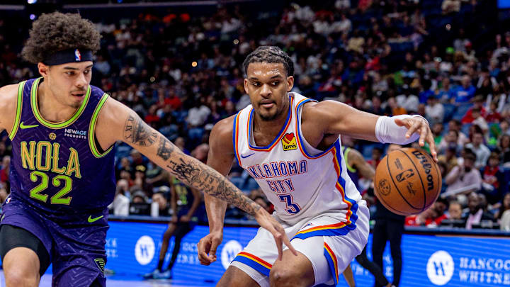 Apr 13, 2025; New Orleans, Louisiana, USA;  Oklahoma City Thunder forward Dillon Jones (3) dribbles against New Orleans Pelicans guard Lester Quinones (22) during the first half at Smoothie King Center. Mandatory Credit: Stephen Lew-Imagn Images