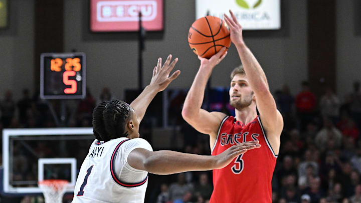 Feb 22, 2025; Spokane, Washington, USA; St. Mary's Gaels guard Augustas Marciulionis (3) shoots the ball against Gonzaga Bulldogs guard Michael Ajayi (1) in the second half at McCarthey Athletic Center. Mandatory Credit: James Snook-Imagn Images