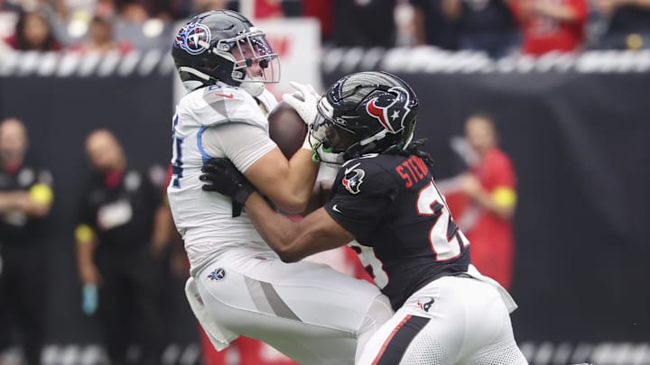 Houston Texans cornerback Derek Stingley Jr. attempts to tackle Tennessee Titans tight end Gunnar Helm.