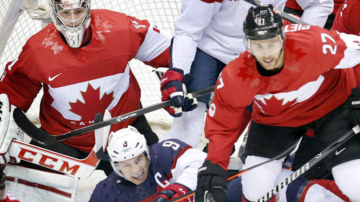 Team USA captain Zach Parise (9) was knocked to the ice in the first period against Canada in the