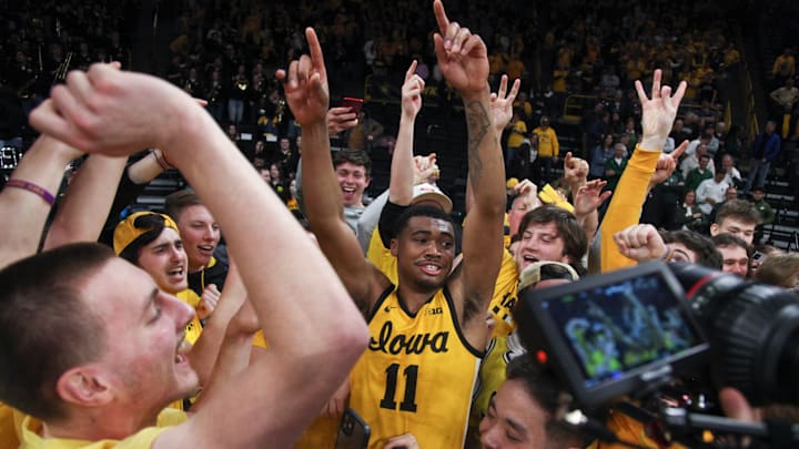 Tony Perkins (11) celebrates with Iowa Hawkeye fans, after a thrilling comeback victory in overtime against the Michigan State Spartans.