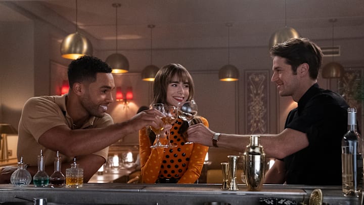 Emily in Paris. (L to R) Lucien Laviscount as Alfie, Lily Collins as Emily, Lucas Bravo as Gabriel in episode 305 of Emily in Paris. Cr. Stéphanie Branchu/Netflix © 2022