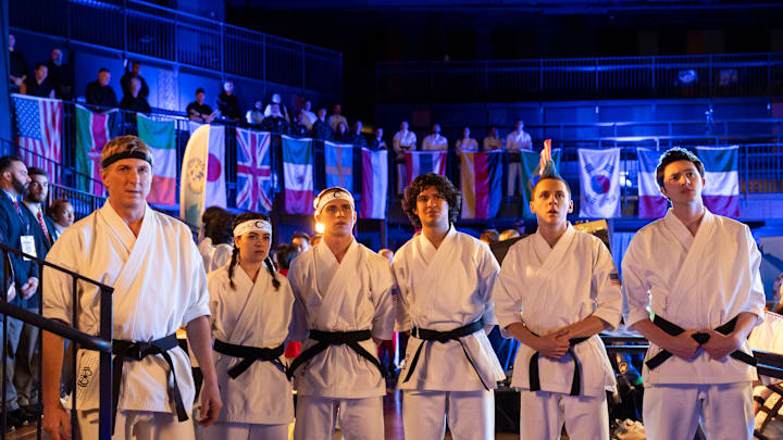 Cobra Kai. (L to R) William Zabka as Johnny Lawrence, Mary Mouser as Samantha LaRusso, Tanner Buchanan as Robby Keene, Xolo Maridueña as Miguel Diaz, Jacob Bertrand as Eli 'Hawk' Moskowitz, Gianni DeCenzo as Demetri in Cobra Kai. Cr. Curtis Bonds Baker/Netflix © 2024