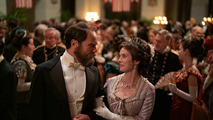 Death By Lightning. (L to R) Michael Shannon as James Garfield, Betty Gilpin as Crete Garfield in episode 103 of Death By Lightning. Cr. Larry Horricks/Netflix © 2024 Death By Lightning. (L to R) Michael Shannon as James Garfield, Betty Gilpin as Crete Garfield in episode 103 of Death By Lightning. Cr. Larry Horricks/Netflix © 2024