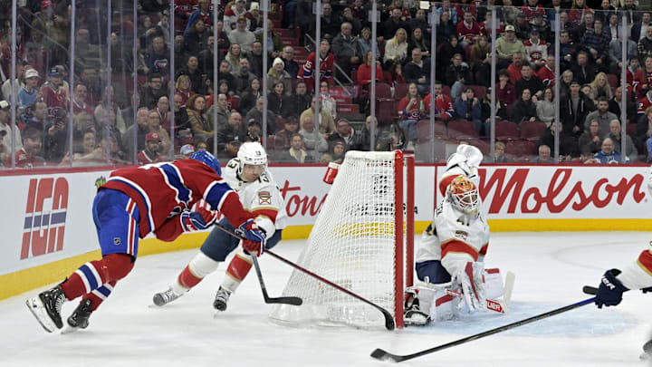 Apr 1, 2025; Montreal, Quebec, CAN;Montreal Canadiens forward Nick Suzuki (14) scores the winning goal against Florida Panthers goalie Vitek Vanecek (41) during the overtime period at the Bell Centre. Mandatory Credit: Eric Bolte-Imagn Images