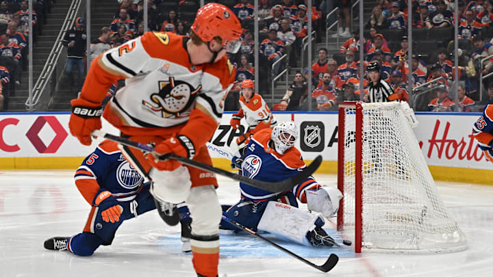 Apr 20, 2026; Edmonton, Alberta, CAN; Edmonton Oilers goalie Connor Ingram (39) reaches for the puck as Anaheim Ducks defenseman Jackson LaCombe (2) looks on in game one of the first round of the 2026 Stanley Cup Playoffs during the second period at Rogers Place. Mandatory Credit: Walter Tychnowicz-Imagn Images