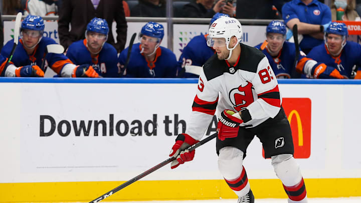 Dec 11, 2021; Elmont, New York, USA; New Jersey Devils defenseman Christian Jaros (83) controls the puck against New York Islanders during the third period at UBS Arena. Mandatory Credit: Tom Horak-Imagn Images