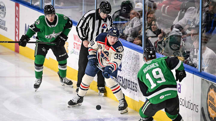 Milwaukee Admirals defenseman Chad Nychuk (39) shoots past Texas Stars forward Cameron Hughes (19) in a game Friday, January 10, 2025, at the UWM Panther Arena in Milwaukee, Wisconsin.