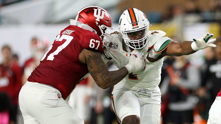 Jan 19, 2026; Miami Gardens, FL, USA; Indiana Hoosiers offensive lineman Kahlil Benson (67) attempts to block Miami Hurricanes defensive lineman Rueben Bain Jr. (4) in the first half during the College Football Playoff National Championship game at Hard Rock Stadium. Mandatory Credit: Nathan Ray Seebeck-Imagn Images