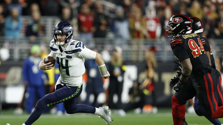Jan 3, 2026; Santa Clara, California, USA; Seattle Seahawks quarterback Sam Darnold (14) rushes the ball against the San Francisco 49ers during the first half at Levi's Stadium. Mandatory Credit: Sergio Estrada-Imagn Images