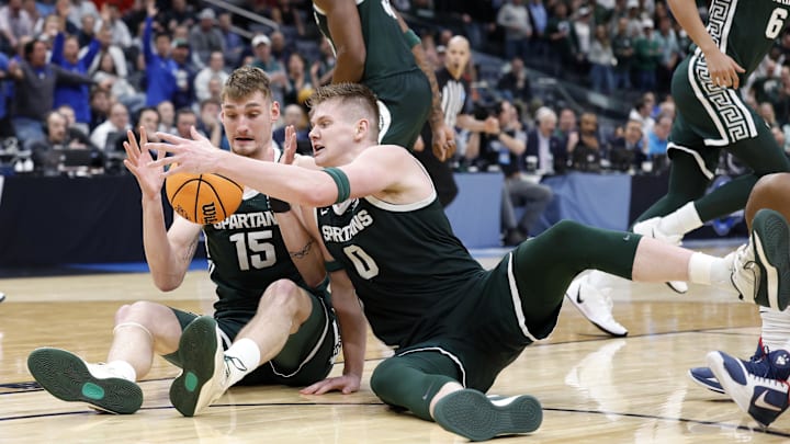 Mar 27, 2026; Washington, DC, USA; Michigan State Spartans center Carson Cooper (15) and forward Jaxon Kohler (0) attempt to get a loose ball against the UConn Huskies  in the second half during a Sweet Sixteen game of the East Regional of the men's 2026 NCAA Tournament at Capital One Arena. Mandatory Credit: Amber Searls-Imagn Images