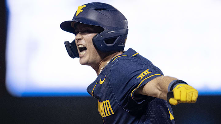 Jun 8, 2024; Chapel Hill, NC, USA; West Virginia Mountaineers Sam White (11) reacts to getting on base against the North Carolina Tar Heels in the ninth inning of the DI Baseball Super Regional at Boshamer Stadium. Mandatory Credit: Jeffrey Camarati-Imagn Images

