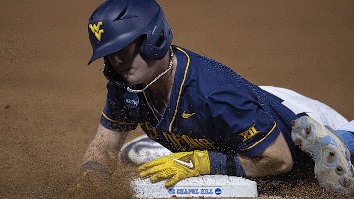 Jun 8, 2024; Chapel Hill, NC, USA; West Virginia Mountaineers Sam White (11) slides safely back to first base against the North Carolina Tar Heels in the sixth inning of the DI Baseball Super Regional at Boshamer Stadium. Mandatory Credit: Jeffrey Camarati-Imagn Images
