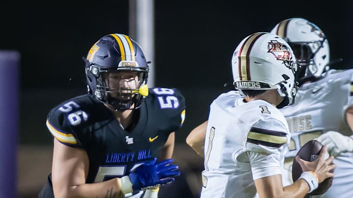 Liberty Hill Panthers defensive end Alister Vallejo (56) chases Rouse Raiders quarterback London Morgan (1) during a play in the fourth quarter at the non-district Class 5A football game on Friday, Sept 6, 2024, at Liberty Hill Panther Stadium in Liberty Hill, TX.