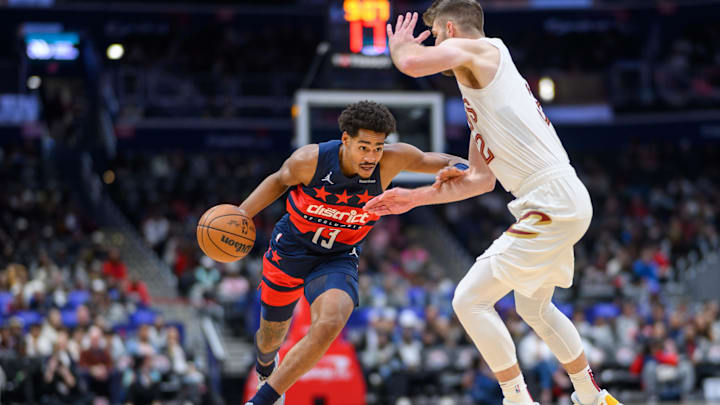 Oct 26, 2024; Washington, District of Columbia, USA; Washington Wizards guard Jordan Poole (13) drives to the basket against Cleveland Cavaliers forward Dean Wade (32) during the first quarter at Capital One Arena. Mandatory Credit: Reggie Hildred-Imagn Images