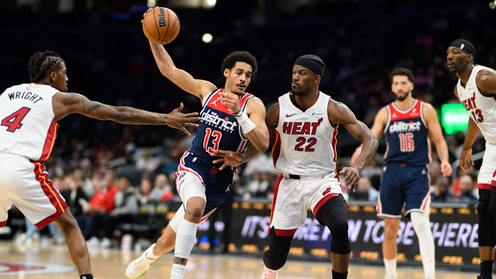 Mar 31, 2024; Washington, District of Columbia, USA; Washington Wizards guard Jordan Poole (13) drives to the basket against Miami Heat forward Jimmy Butler (22) during the third quarter at Capital One Arena. Mandatory Credit: Reggie Hildred-Imagn Images
